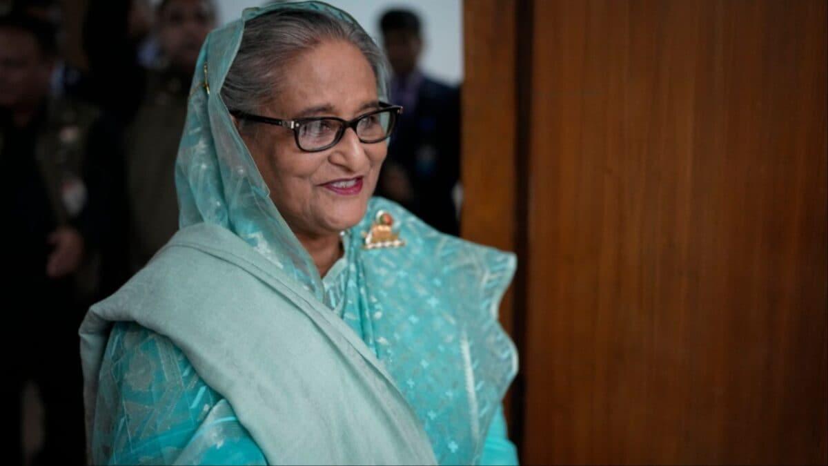 Sheikh Hasina smiling in a teal sari