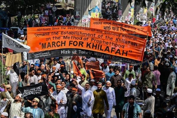 Sheikh Hasina: A large protest march carrying banners, Dhaka
