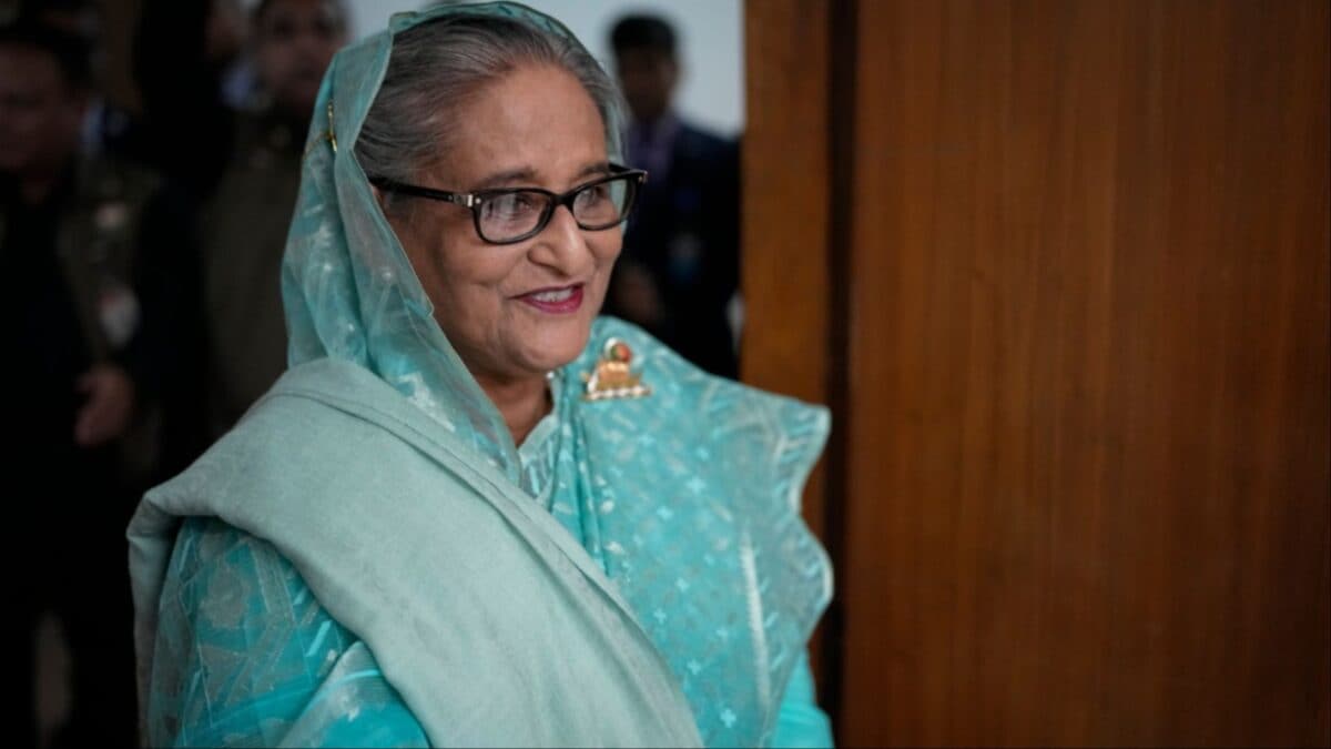 Sheikh Hasina smiling in a teal sari